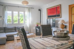 a living room with a couch and a table at Can Content - Playa de Muro in Muro