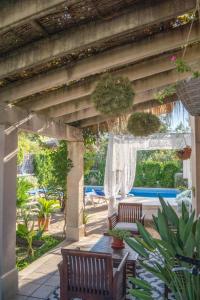 an outdoor patio with two chairs and a table at Can Content - Platja de Muro in Playa de Muro