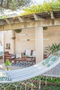 a hammock on the patio of a house at Can Content - Playa de Muro in Muro