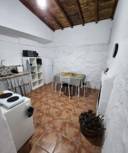 a kitchen with a table and a stove and a table at Vv Casa Muya in Icod de los Vinos