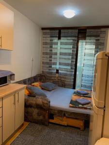 a kitchen with a bed in the middle of a room at Apartman AM Sarajevo in Sarajevo