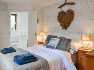 a bedroom with a bed with two towels on it at Folly Lodge in Sewerby