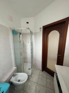 a bathroom with a sink and a toilet and a shower at Mya’s Home in Cinisello Balsamo