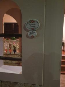 a door with a plate on the side of a house at La Casa di Bonaria in Sestu