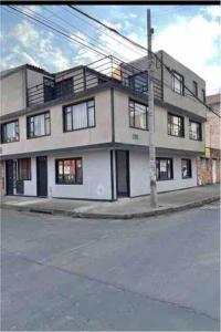 a large white building on the corner of a street at Apartamento Acogedor y muy central en Bogotá in Bogotá