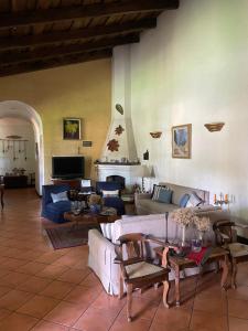 a living room with couches and tables and a fireplace at Casa San Miguel in Antigua Guatemala