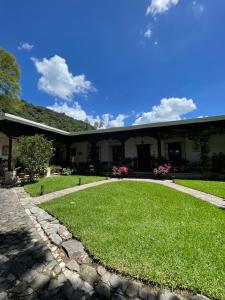 a house with a grassy yard in front of it at Casa San Miguel in Antigua Guatemala