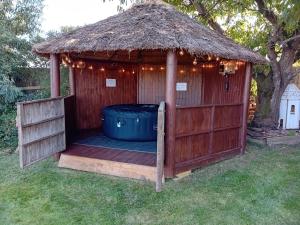 a gazebo with a trash can in the yard at Love Nest in Deal