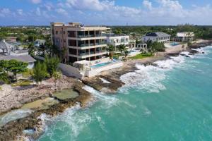 an aerial view of a resort next to the water at Luxury Ocean front SeaDreams 2 with 7 Mile Beach Views in West Bay