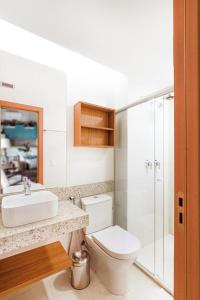 a bathroom with a toilet and a sink and a shower at Salinas Exclusive Resort in Salinópolis