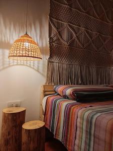 a bedroom with a bed with a colorful blanket and a lamp at CASA LITA con terrazzo in Ravenna