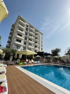 a hotel with a swimming pool in front of a building at YOUR CHOICE in Bar