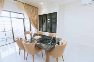 a dining room with a black marble table and chairs at Buzovna Villas in Buzovna