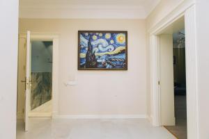 a painting hanging on a wall in a room at Buzovna Villas in Buzovna