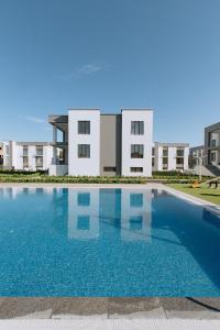 a large swimming pool in front of a building at Buzovna Villas in Buzovna