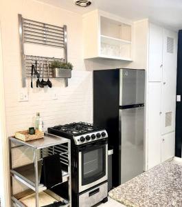a kitchen with a stove and a refrigerator at Beautiful Bright Condo Steps Away from the Beach in Long Beach