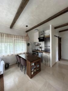 a kitchen with a table and chairs in a room at El Rincón de Manuela in Sarria