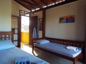 a bedroom with two beds and a window at Casa Manhapeba in Ilha de Boipeba