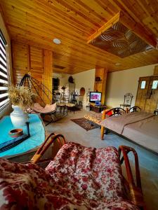 a living room with a bed and a couch at Oak Farm مزرعة الملّول in Ajloun