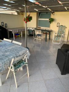 a room with a bed and chairs and a table at Terrazza sul mare in Scoglitti
