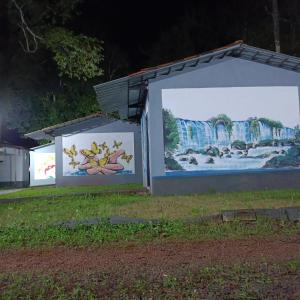 zwei große Plakate an der Seite eines Gebäudes in der Unterkunft Dom Del'Gaudio Melhor lugar do mundo in Foz do Iguaçu