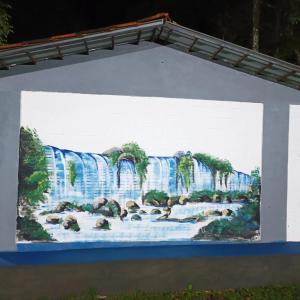 a painting of a waterfall on a wall at Dom Del'Gaudio Melhor lugar do mundo in Foz do Iguaçu