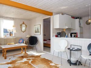 a kitchen and living room with a table and chairs at 6 person holiday home in Juelsminde in Sønderby