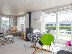 a dining room with a table and chairs at 6 person holiday home in Juelsminde in Sønderby