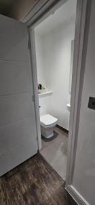 a bathroom with a white toilet in a room at Cosy studio flat in North London in London