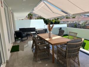 a patio with a wooden table and chairs at Las Terrazas in Adeje