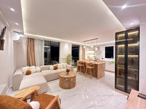 ein Wohnzimmer mit einem weißen Sofa und einer Küche in der Unterkunft Deniz manzaralı, özel tasarımlı ev . in Mezitli