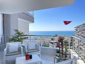 a balcony with white chairs and a view of the ocean at Deniz manzaralı, özel tasarımlı ev . in Mezitli