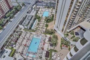 an overhead view of a pool in a city at SIGNATURE MGM TOP 38th FLOOR PENTHOUSE, BEST DELUXE BALONY STRIP VIEW SUITE, NO RESORT FEE, FREE VALET, SHORTEST WALK 2 MGM in Las Vegas
