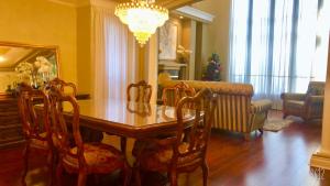 a dining room table with chairs and a chandelier at Vancouver Airport Blueberry Manor in Richmond