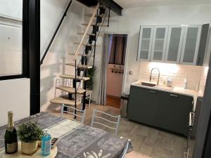 a kitchen with a table and a staircase in a room at B1 Appart 2022 - 10min PARIS/EXPO - 5 rooms/6 beds in Bagneux