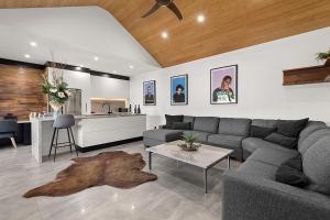 a living room with a couch and a table at North Adelaide Boutique Stays Accommodation in Adelaide