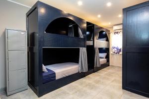 A bed or beds in a room at Bedcoin Hostel