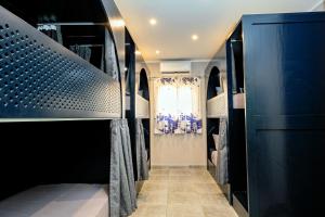A bed or beds in a room at Bedcoin Hostel