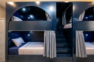 A bed or beds in a room at Bedcoin Hostel