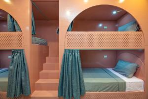 A bed or beds in a room at Bedcoin Hostel