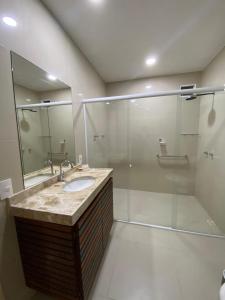 a bathroom with a sink and a shower at Sunset Beach Hotel in Taíba