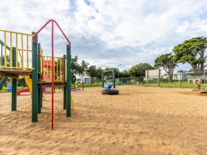 a park with a playground with play equipment at NRMA Portland Bay Holiday Park in Portland