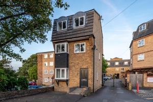 a house with a black roof on a street at COZY 3 Bed House With Garden & Parking in Rochester, Kent Mins to Train Station, WiFi in Rochester