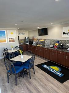 a restaurant with tables and chairs and a kitchen at Days Inn by Wyndham Temple in Temple