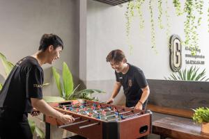 two men playing a game of chess at The Glomad Danang Hotel in Da Nang