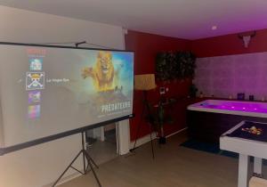 a large projection screen in a room with a tub at House Spa Privatif - Jaccuzi et Sauna in Livry-Gargan
