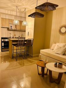 a living room with a bed and a kitchen at Capibara 2- alquiler temporario. in Corrientes