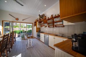 a kitchen with a counter and a table in it at Poet's Cottage Stanley in Stanley