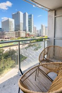 2 sillas en un balcón con vistas a la ciudad en Family oriented Downtown Toronto 2BDRM Condo with Parking & office space en Toronto