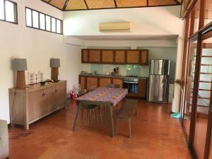 a large kitchen with a table and a refrigerator at Villa “Mango” in Villa Vista, Hua Hin in Khao Tao